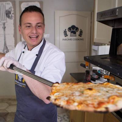 a man holding a slice of pizza