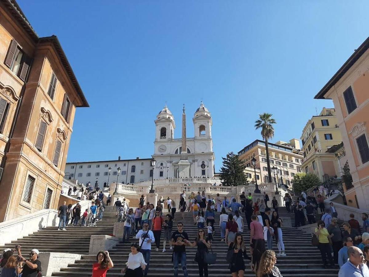 a group of people walking in front of a building