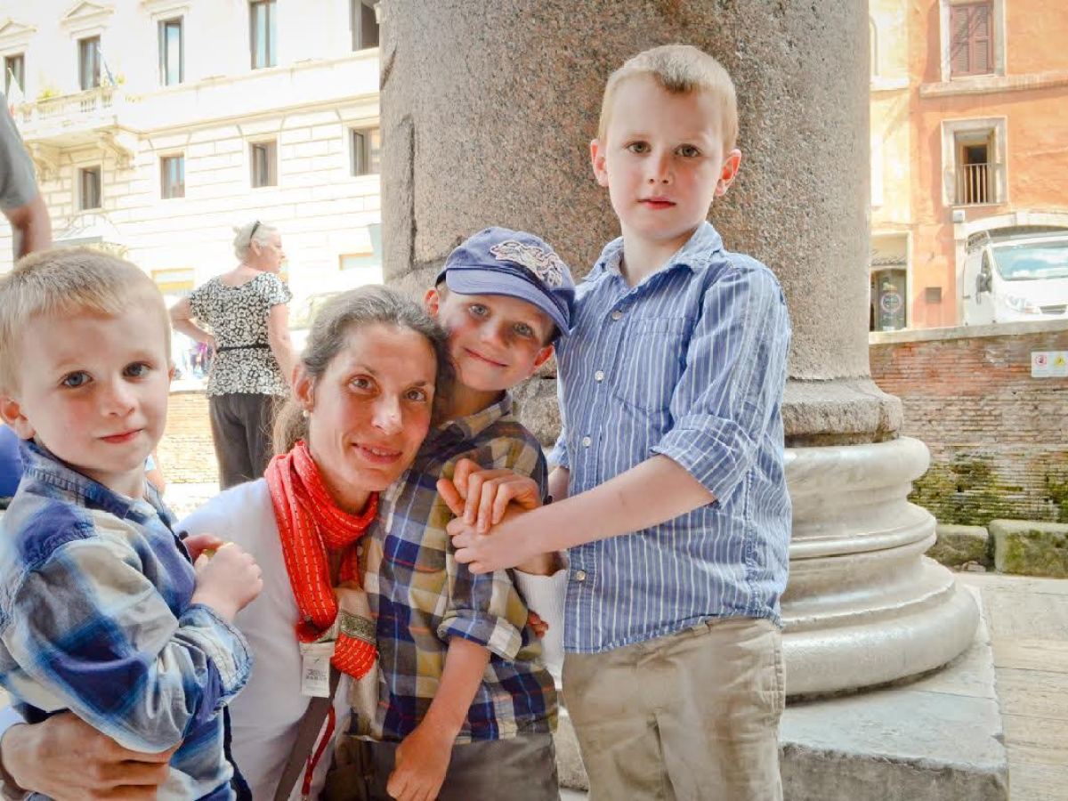 a little boy standing in front of a building