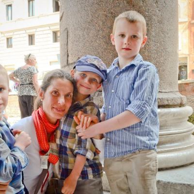 a little boy standing in front of a building