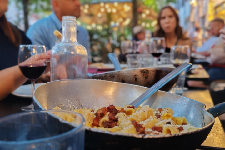 Bowl of carbonara in front of a woman